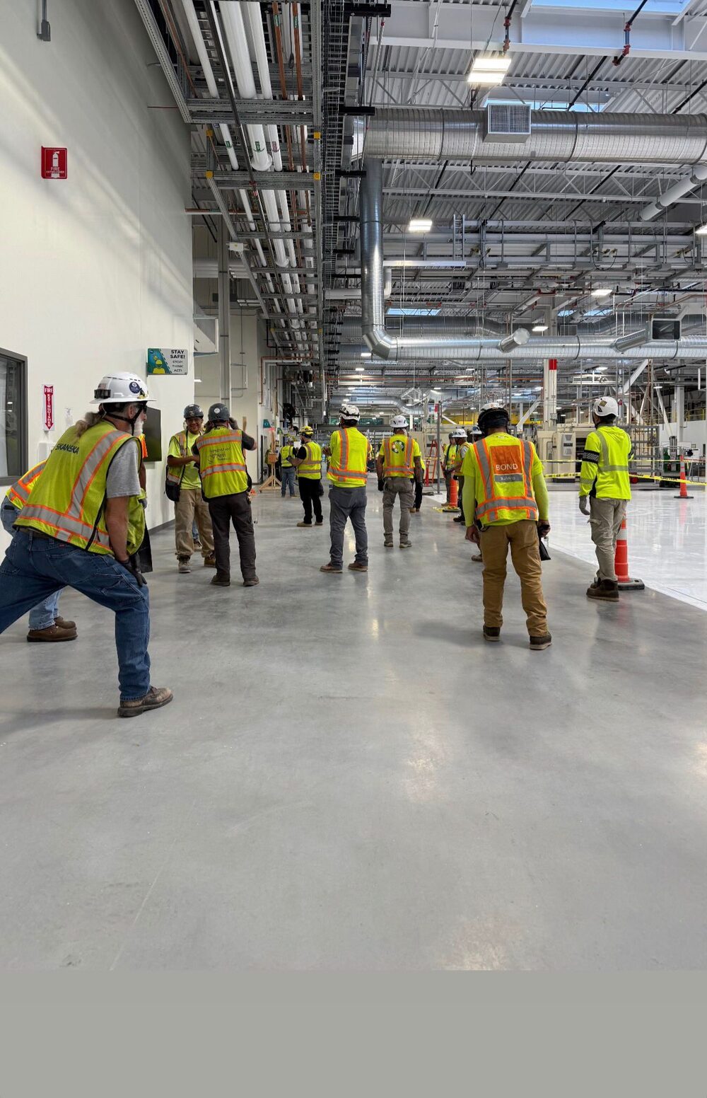 Construction crew in safety vests working inside a large commercial building in Florida