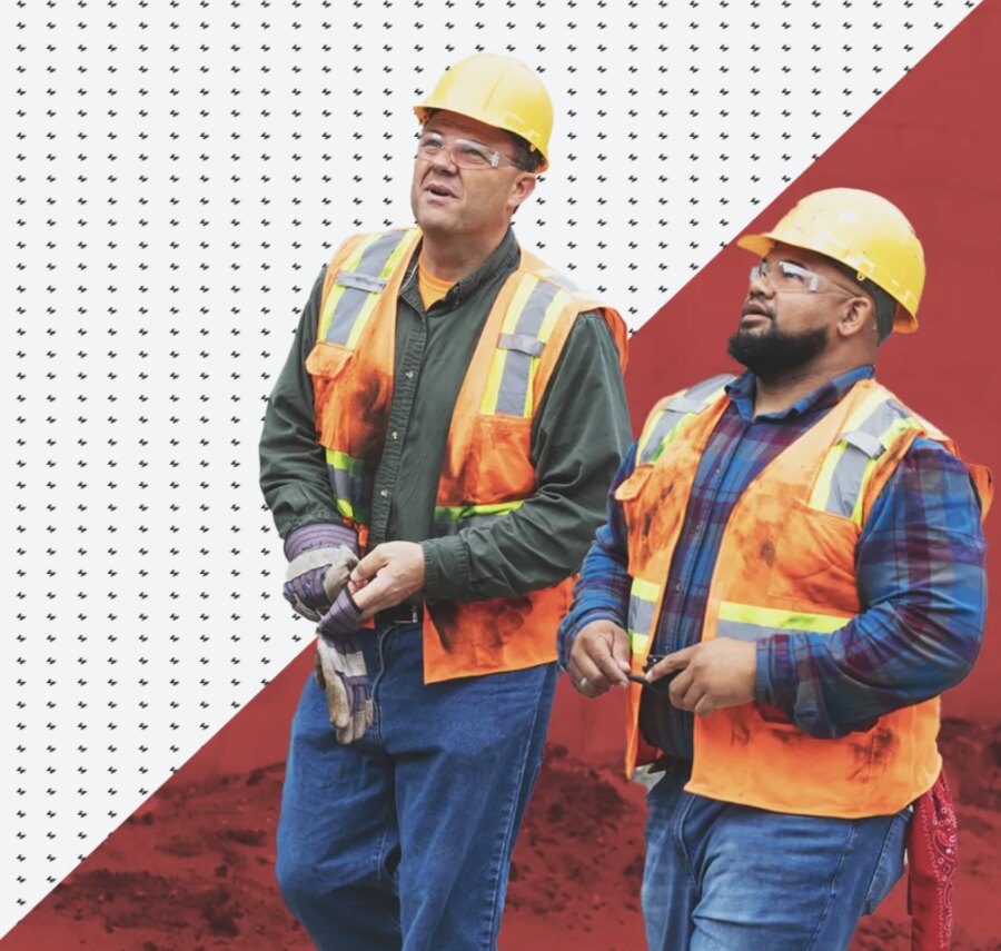 Two Workforce Pros construction workers in hard hats and safety vests on a Florida job site